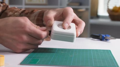 Adult Hands Repairing a White Electrical Outlet