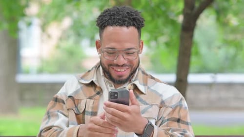 Smiling Young Man Waving During a Video Call