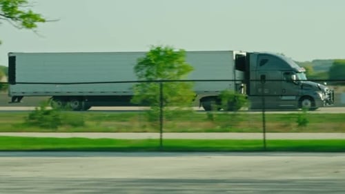 Truck Traveling Along Highway on Sunny Day