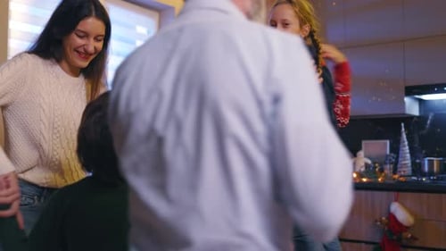Family Gathered Around Christmas Tree in Festive Home