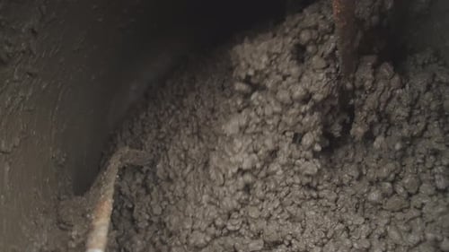 A Closeup View Showcasing the Intricate Mixed Materials Present Inside an Industrial Mixer