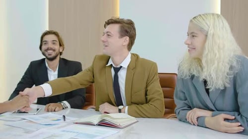 Young executive and partnership and sitting handshake for agreement together in the office