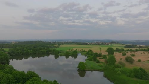 Aerial Footage of Calm Forest Lake at Dusk