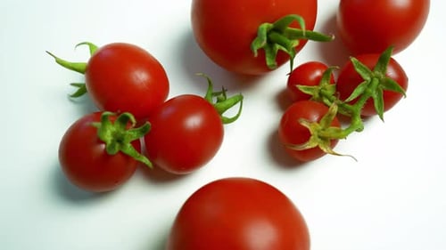 Bright Red Cherry Tomatoes on White Surface Zooming In