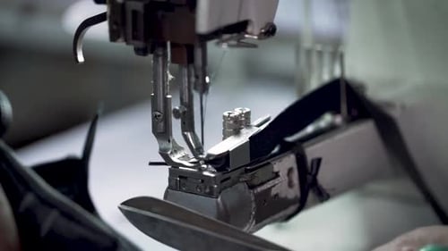 Closeup Shot Of Tailor Stitching And Cutting Leather In A Sweatshop Factory
