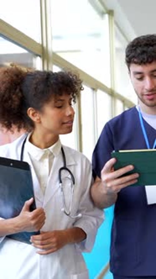 Medical Professionals Collaborating on Patient Care in Hospital Corridor