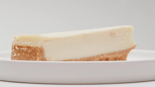 Delicious Slice of Cheesecake on White Plate