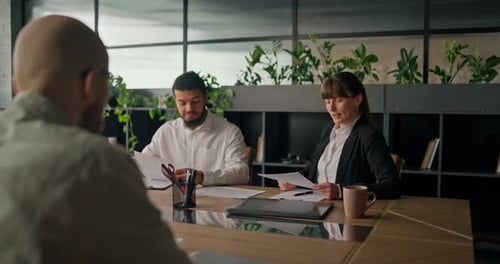 Business Meeting in Modern Office with Plants