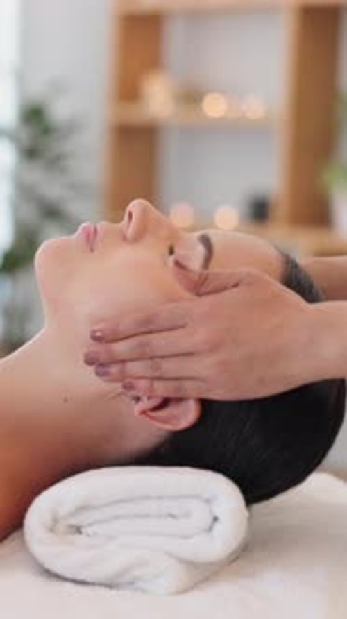 Woman Receives Relaxing Facial Massage at Day Spa