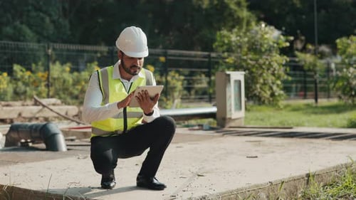 Inspector Squats Controlling Waste Water Treatment Plant at Countryside
