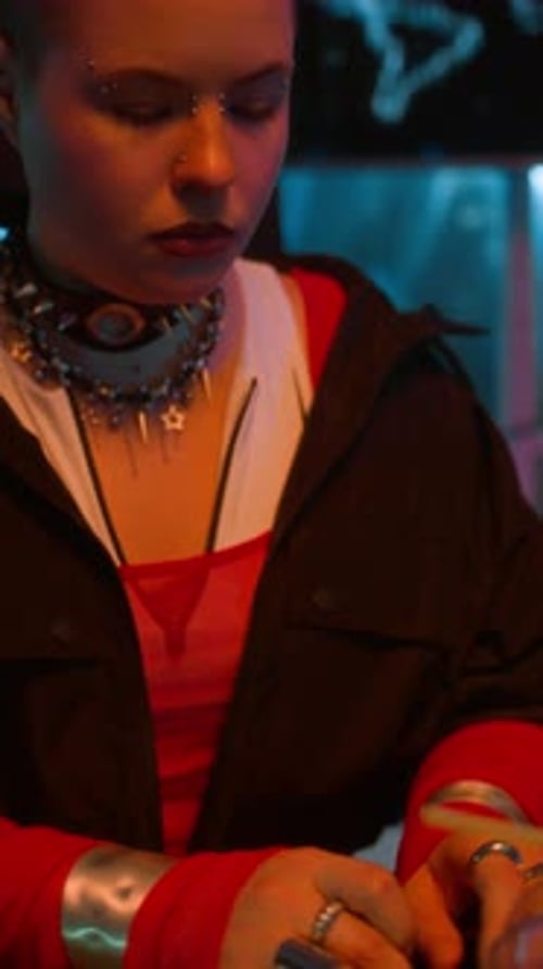 Stylish Woman Typing on Keyboard in Dimly Lit Room