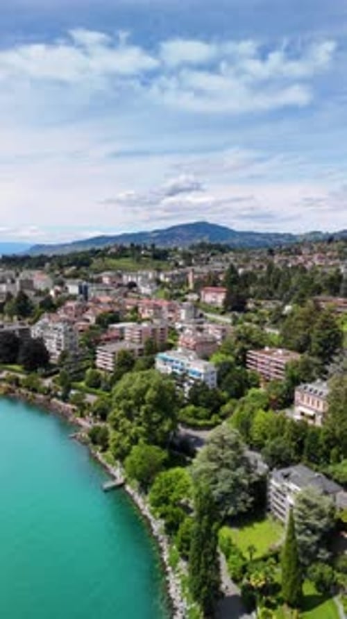 Lake Geneva shore Montreux town Switzerland aerial drone vertical video