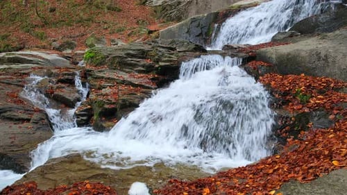 Water flowing over rocks in a mountain creek during a colorful and scenic autumn season