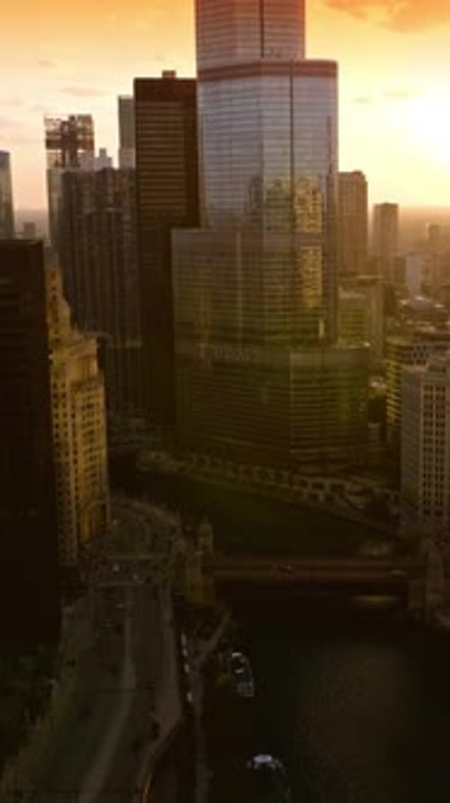 Chicago River in the city downtown. Darkening buildings of metropolis at coming evening.