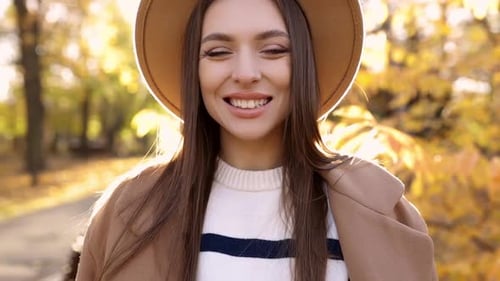 Closeup of a Beautiful Drunepka in a Brown Hat Walking Outdoors in the Park Posing for the Camera