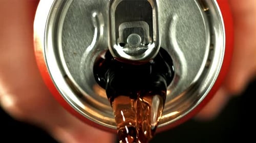Soda Pouring from a Red Can Close Up