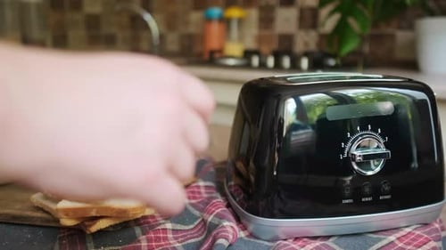 Toasting Bread Slices for Breakfast in Home Kitchen