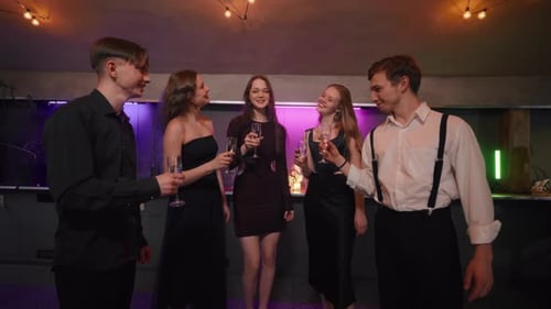 Elegant Young Adults Celebrating with Champagne Indoors