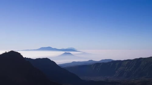Mountains Above the Fog Layer in Clear Sky