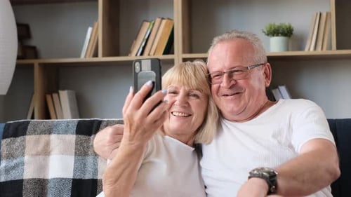 Smiling Senior Couple Taking a Selfie at Home