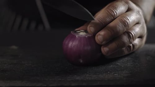 Chef Cutting Red Onion in Half: Close Up Shot. Food Prep.