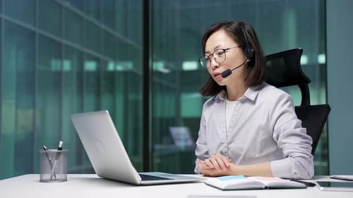 Woman on Video Call in Modern Office at Night