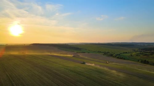 Aerial View of Combine Harvesters Working During Harvesting Season on Large Ripe Wheat Field