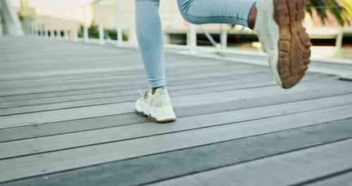 Legs Running in Sneakers on a Bridge