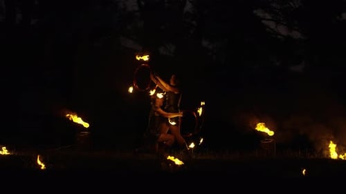 Duo Performing Fire Dance at Night