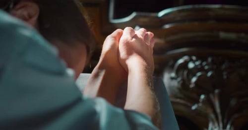 Woman raised her hands to heaven in worship to God in church. Folded hands in prayer.