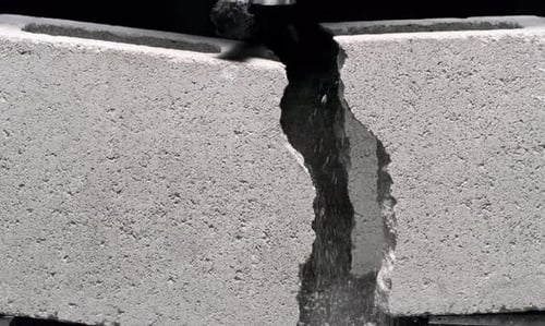 Impact Collection: A concrete brick cracking from the center