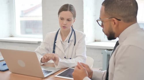 Doctor Consulting with Patient in Office
