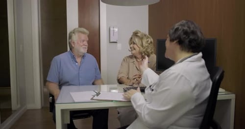 Senior Couple Consulting with Doctor in Office