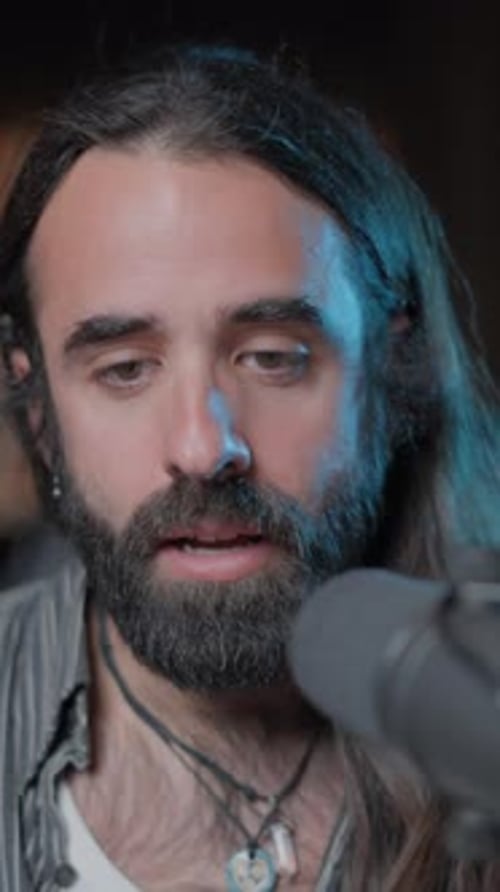 Close Up of Man Speaking Into Microphone