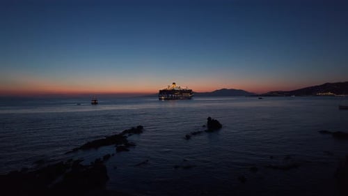 Passenger ship sailing in the Aegean Sea, Greece, at twilight