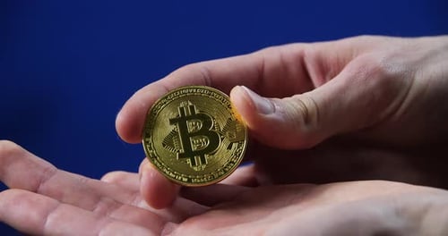 Hand Holding Golden Bitcoin Cryptocurrency