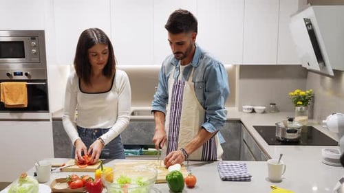 Couple Cooking Healthy Salad in Modern Kitchen