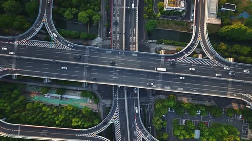 Aerial Top Down View of a Busy Junction Reveals a Multitude of Vehicles Traveling on Various