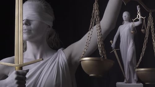 Full Statue of Themis is Standing Next to the Small Version