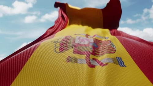 Realistic Spain Flag Waving Under Sunny Blue Sky