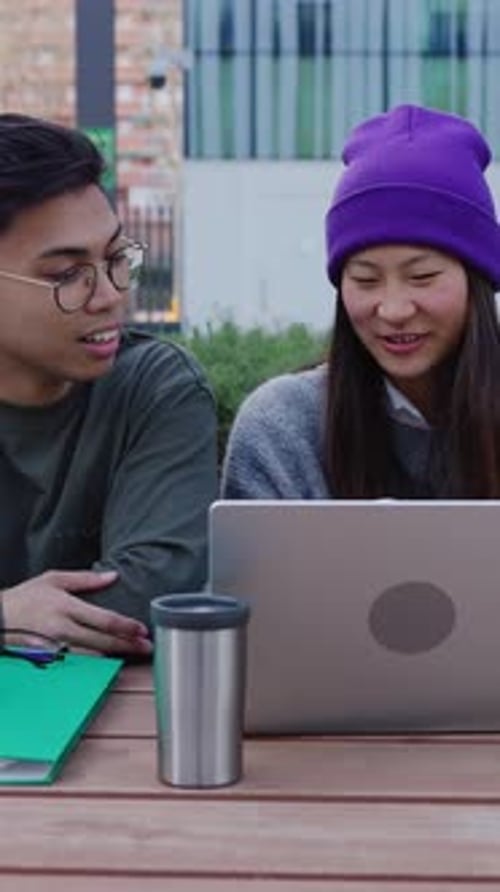 Young Asian Student Friends Studying Together on Table College Campus