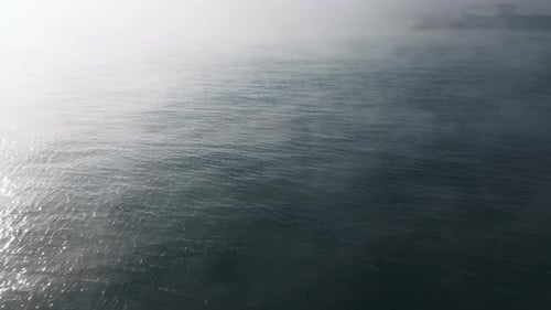 Drone Flight Over the Sea in the Fog in the Morning