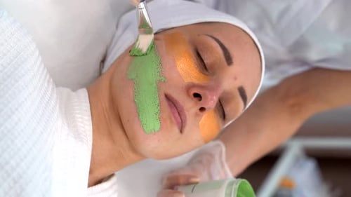 The Cosmetologist Applies a Mask to the Client Face Makes Procedures in the Spa or Salon Closeup