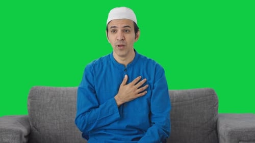 Sick Muslim man suffering cold and cough Green screen
