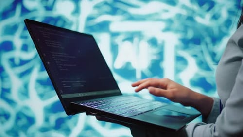 Close Up Shot of IT Expert Using AI System and Laptop