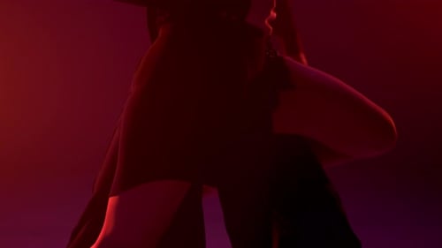 Unknown Sensual Woman Lifting Leg on Dance Partner Indoors. Unrecognizable Ballroom Couple