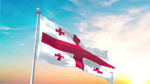 Flag of Georgia Waving Against Vibrant Sunset Sky