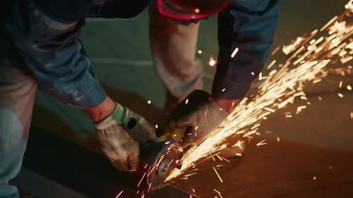 Technician Polishing Edge with Sparks Closeup of Worker Grinding Metal Edge with Sparks Flying Away