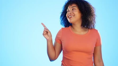 Mockup, advertising and woman pointing at deal, sale or copy space isolated in a studio blue