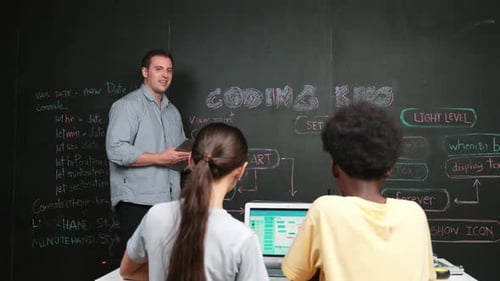 Smart teacher holding tablet while explain about programming system. Edification